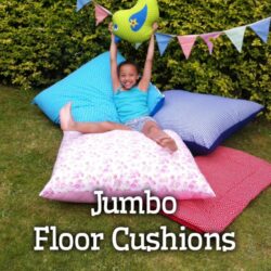 Home screen Jumbo Floor Cushions A young child sitting on a large floor cushion for kids.