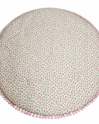 Handmade round padded kids floor mat in floral rose fabric with pink pom-pom trim