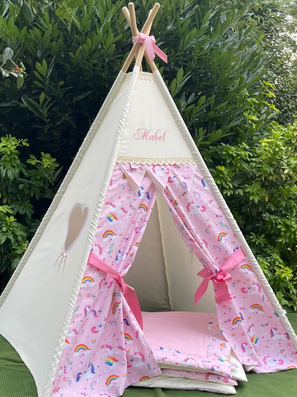 Angled view of personalised pink unicorn kids teepee tent with pink ribbon tie backs
