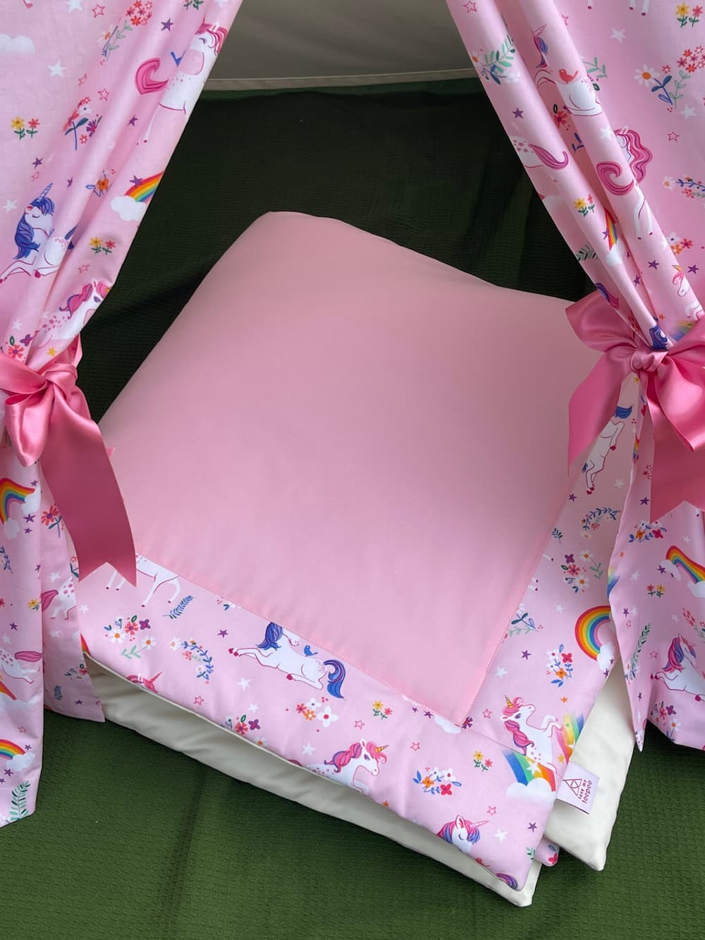 Coordinating padded floor mat inside personalised pink unicorn kids teepee tent